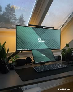 a computer monitor sitting on top of a desk next to a keyboard and mouse in front of a window