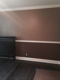 an empty room with a radiator and wooden floors in it, along with hard wood flooring