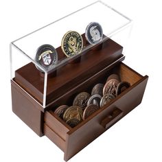 a wooden box filled with lots of coins