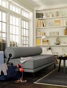 a living room filled with furniture and bookshelves