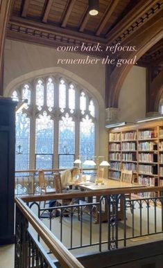 the interior of a large library with lots of bookshelves and tables in it