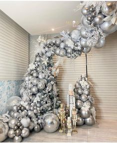 a christmas tree made out of silver and white ornaments