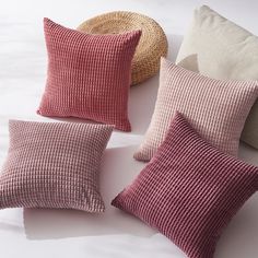 four different colored pillows sitting next to each other