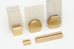 brass hardware is displayed on a white surface with some papers and instructions to make it look like hexagonal shapes