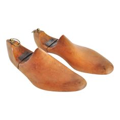 two wooden shoes with metal buckles on them