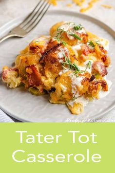 a white plate topped with tater tot casserole next to a fork