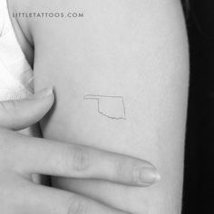 a woman's arm with a small tattoo on the left side of her body