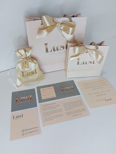 the wedding stationery is laid out on top of the table with its matching gift bag