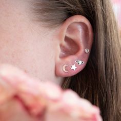 These sterling silver post earrings features a moon and star design—one post holds a crescent moon, the other holds a single star. …………………………………. Details: Available in Sterling Silver Dimensions: 11.8 x 6.9mm Post Diameter: .036" (0.91mm) PostLength: 7/16" (11.11mm) Made for lobe piercings Waterproof and can be worn every day Hypoallergenic About Your Jewelry If you are not wearing your jewelry it is best to store it in a cool, dry place such as your gift box that is included in your ord Star-shaped Sterling Silver Piercings, Moon And Star Design, Two Moons, Lobe Piercings, Earrings Butterfly, Lobe Piercing, Moon And Star, Star Design, Silver Moon