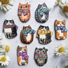 six cat magnets with different designs on them