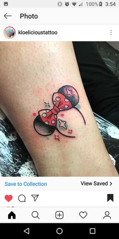 a small tattoo on the leg of a woman's leg, with an image of mickey