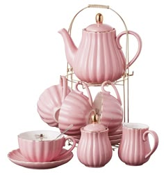 a pink tea set with cups and saucers