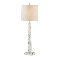 a white table lamp with a beige shade on the base and a wooden block underneath it