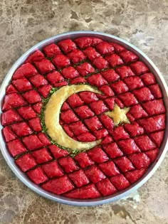 a plate with food in the shape of a crescent and star, on top of a table