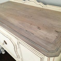 an old white dresser is painted gray and has been stripped off with some varnishing