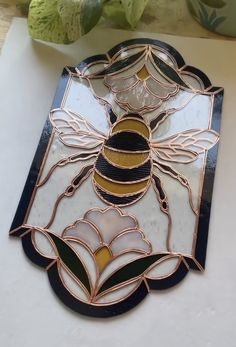 a stained glass plate with a bee on it