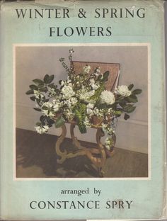 the front cover of winter and spring flowers by constance spry, with an arrangement of white flowers in a vase