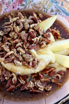 pecans, apples and raisins are mixed together in a dish on a plate