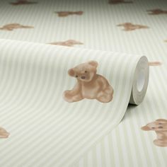 a roll of tape with a brown teddy bear on it's face and stripes in the background