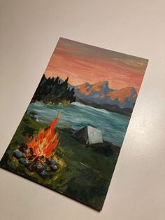 a painting of a campfire with mountains in the background