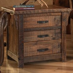 a wooden table with two drawers and a book on top