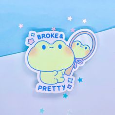 a sticker depicting a frog holding a magnifying glass with the words broke pretty on it