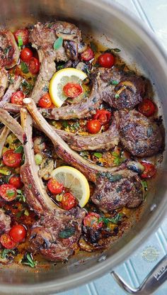 a pan filled with meat and vegetables on top of a table