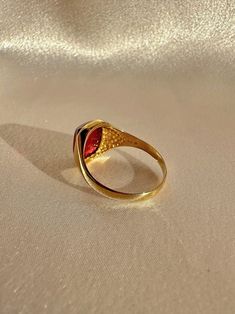 Antique 18k yellow gold ring from the United Kingdom. This signet ring features a vibrant synthetic ruby cabochon. Great antique condition Size: 7.5 resizable* Weight: 3.5 grams Band: 11.1 mm (front), 1.7 mm (back) Synth Ruby: 8.3 mm x 10.0 mm Hallmarks:18CT Vintage Ruby Cabochon Ring, Antique Cabochon Ruby Ring Gift, Antique Ruby Cabochon Ring, Luxury Antique Cabochon Signet Ring, 14k Gold Red Cabochon Ruby Ring, Yellow Gold Ring, 18k Yellow Gold Ring, Signet Ring, Yellow Gold Rings