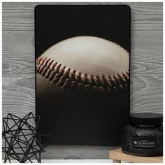 an image of a baseball on a wooden background with the ball in the air and some other items around it