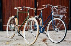 two bikes parked next to each other in front of a building