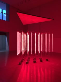 an art installation with red lights in a room