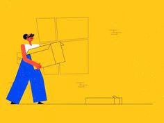 a woman carrying boxes down a yellow wall