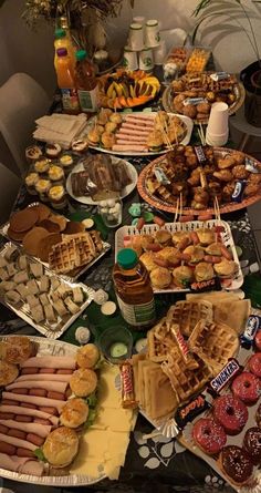 a table topped with lots of different types of foods and desserts on top of it