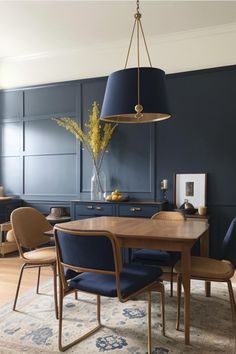 a dining room with blue walls and chairs