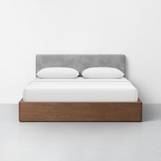 a bed with two pillows on top of it