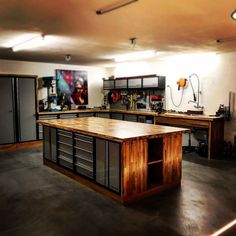 an empty garage with lots of workbenches and tools on the counter top,