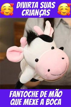 a stuffed cow is being held up in the air