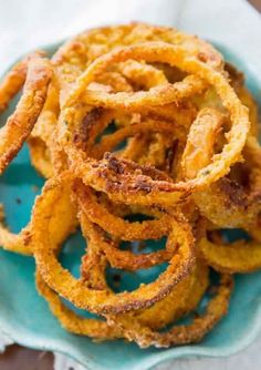 fried onion rings on a blue plate