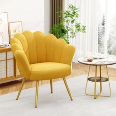 a yellow chair sitting next to a table on top of a white carpeted floor