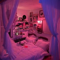 a bedroom with pink lights and purple curtains