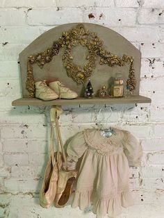 there is a wall shelf with shoes and other items hanging on the wall next to it