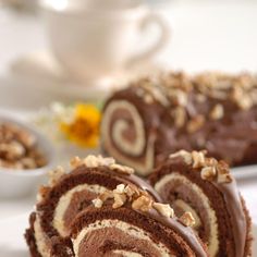 there are two pieces of chocolate roll on the plate and one piece has walnuts