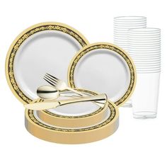 a set of gold and white dinnerware