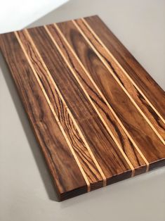 a wooden cutting board sitting on top of a table