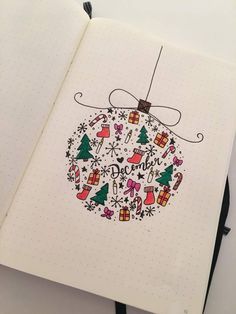 an open notebook with a christmas ornament drawn on the cover and decorated with doodles