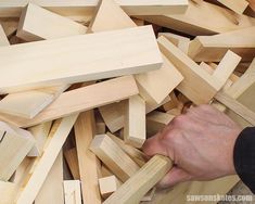 a man is working with wood blocks