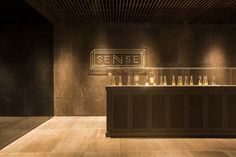 an empty bar with bottles on the counter and lights above it in a dimly lit room