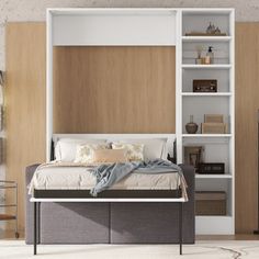 a bed sitting next to a book shelf filled with books