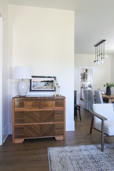 a living room with white walls and wooden furniture in it's centerpieces