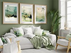 a living room filled with white furniture and green accents on the walls, along with plants